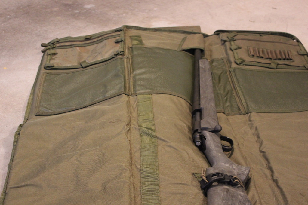 See the hump to the left of the rifle? That's the backpack straps.